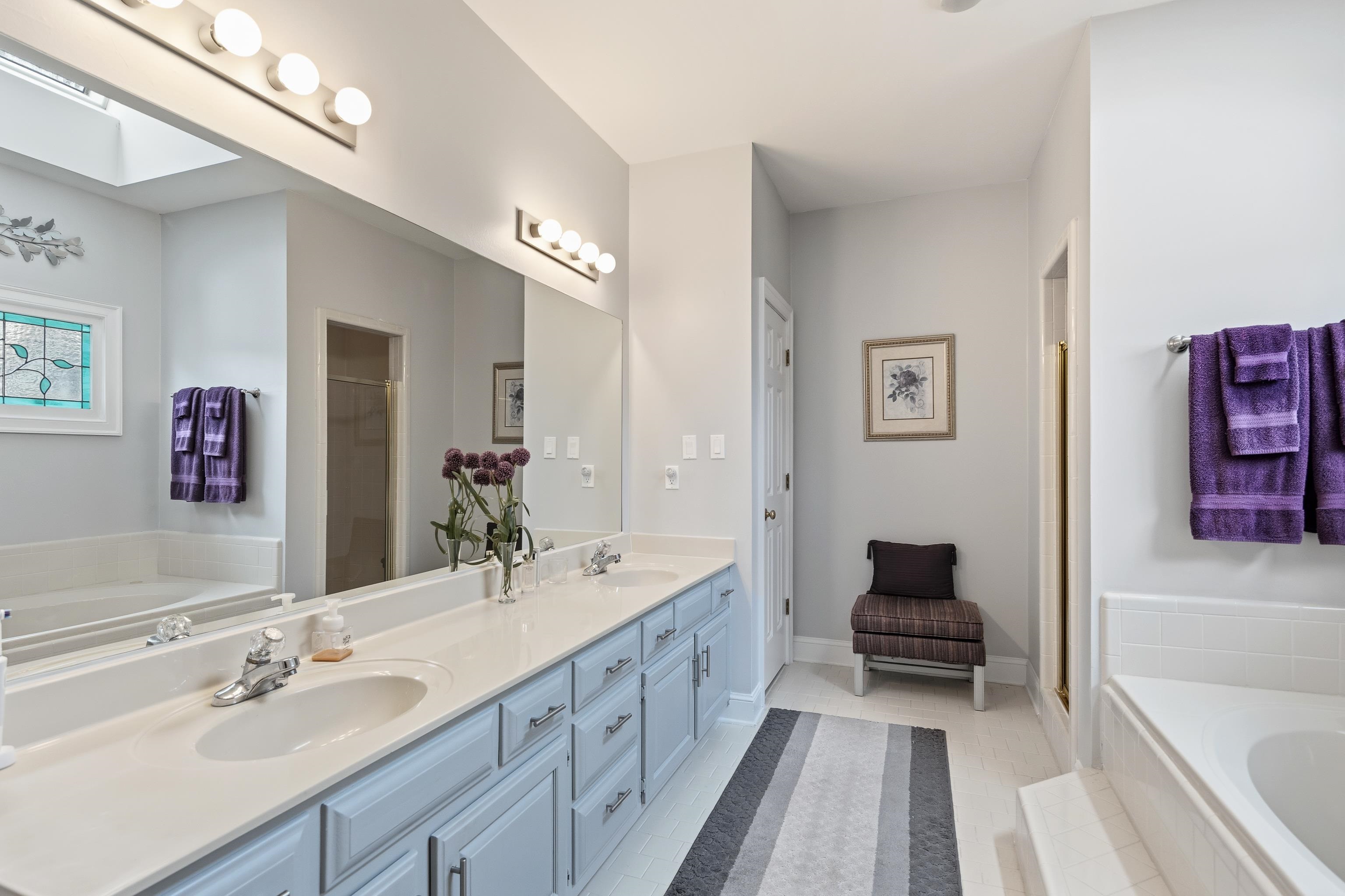 10281 Peyton Path Cove Collierville, TN 38017 - Photo 24 of 40 Bathroom with a bath, double vanity, a shower stall, and light tile patterned flooring