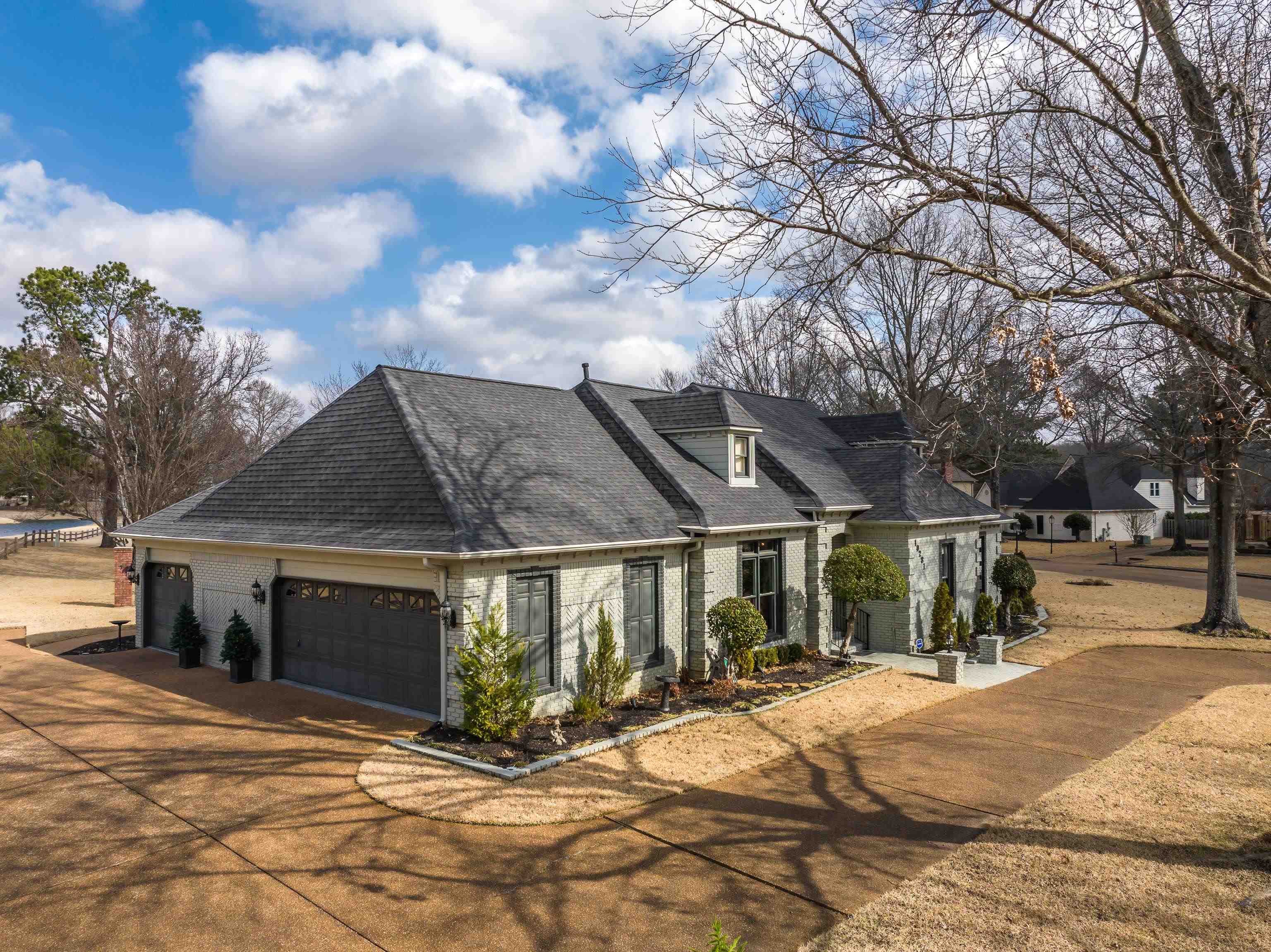 10281 Peyton Path Cove Collierville, TN 38017 - Photo 28 of 40 View of front facade featuring brick siding, a shingled roof, driveway, and a garage