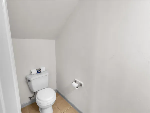a white toilet sitting next to a shower