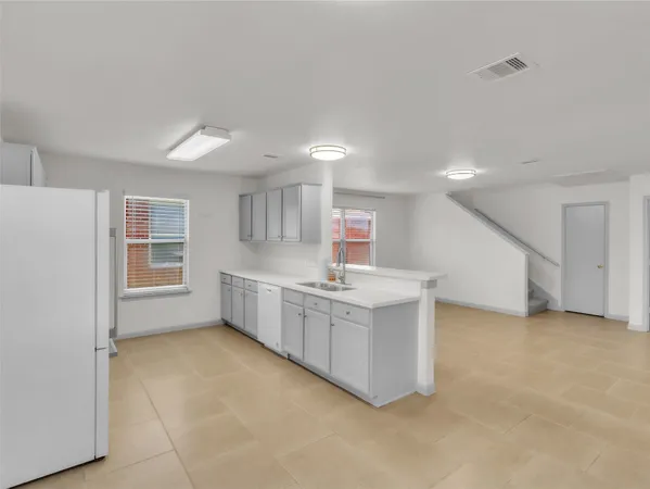 a kitchen with stainless steel appliances a sink and cabinets