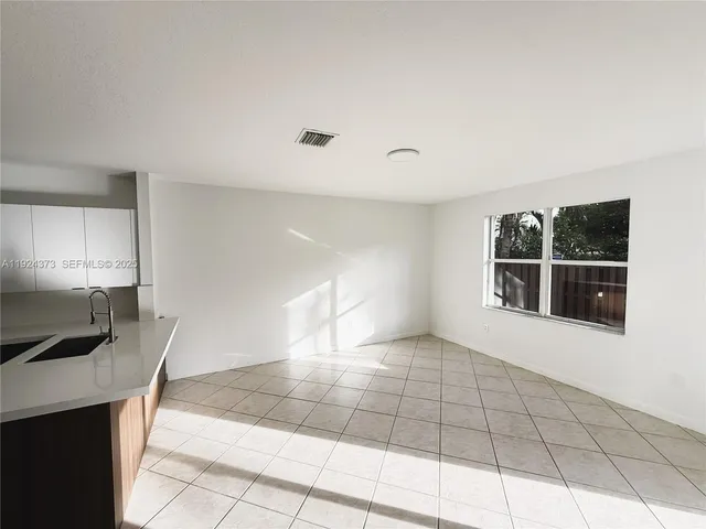 a kitchen with a sink cabinets and a stove