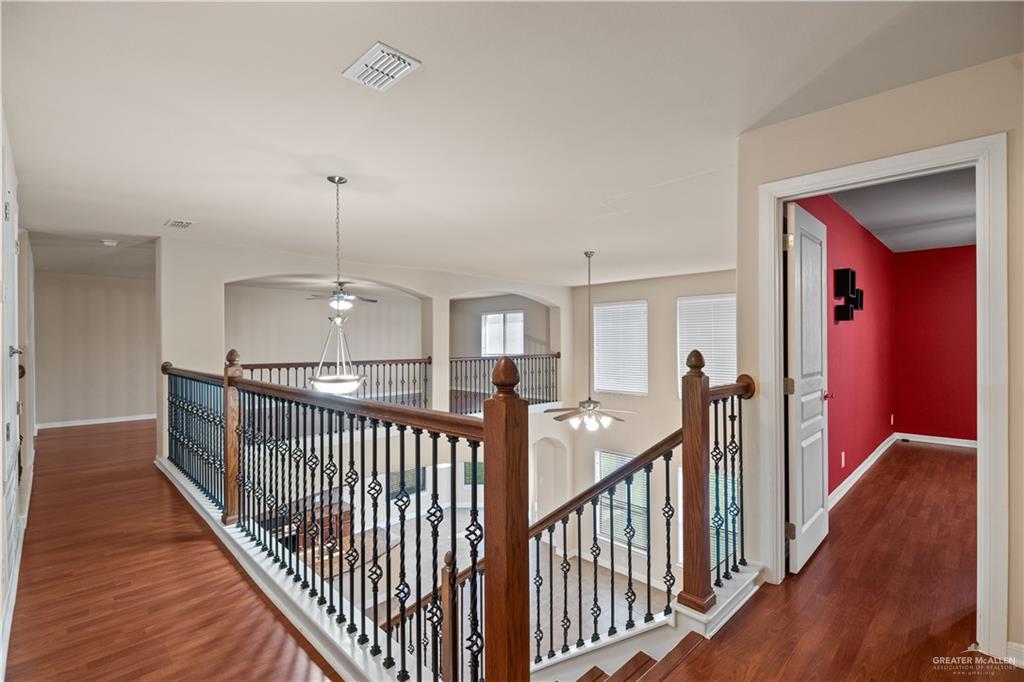 2806 San Ricardo Street Mission, TX 78572 - Photo 12 of 29 a view of a hallway with wooden floor and stairs