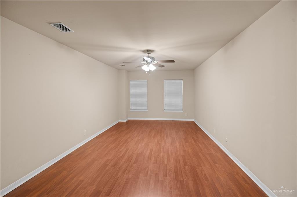 2806 San Ricardo Street Mission, TX 78572 - Photo 14 of 29 wooden floor in an empty room with a window