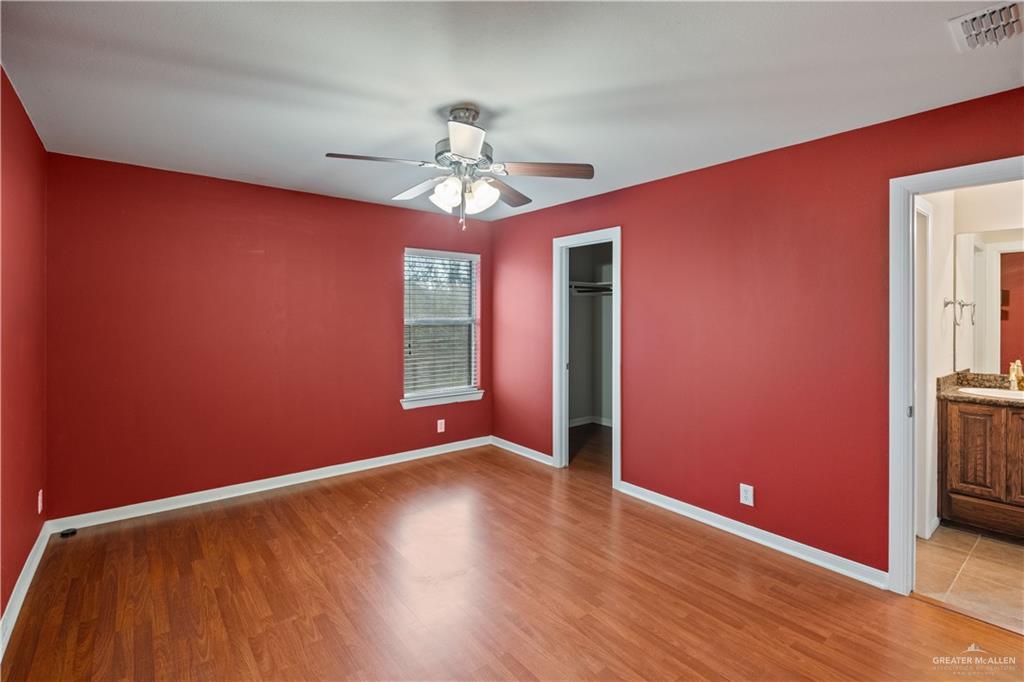 2806 San Ricardo Street Mission, TX 78572 - Photo 15 of 29 an empty room with wooden floor chandelier and windows