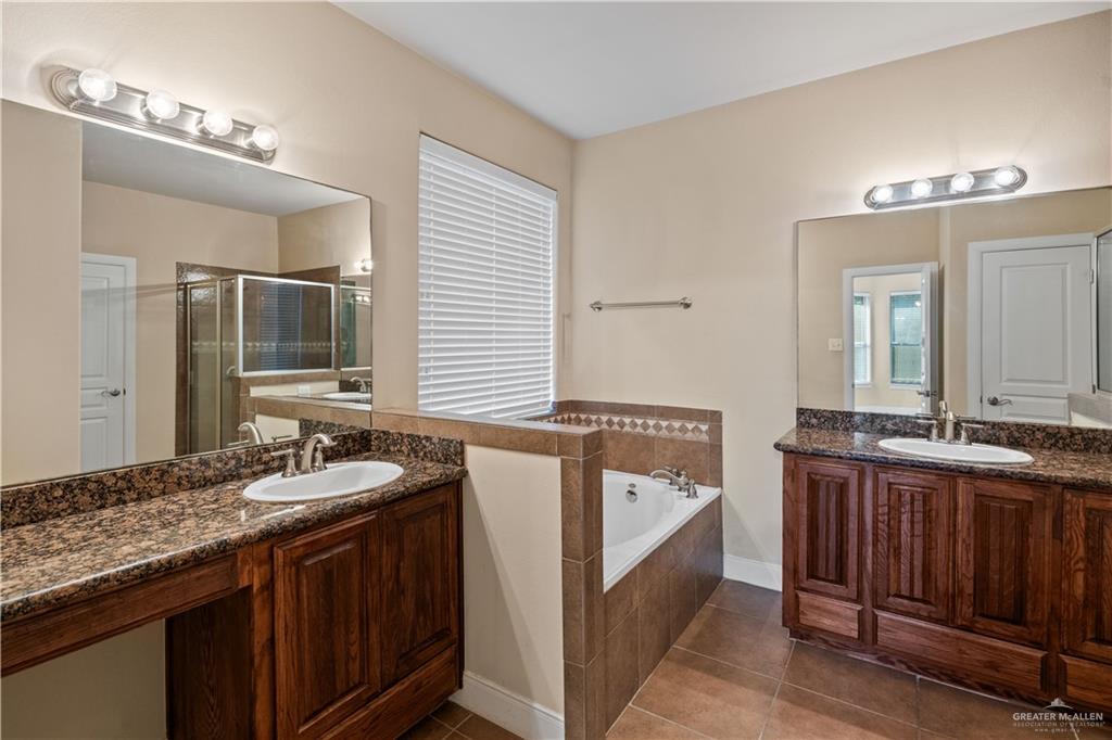 2806 San Ricardo Street Mission, TX 78572 - Photo 22 of 29 a en suite bathroom with a granite countertop double vanity sink a mirror and a bathtub
