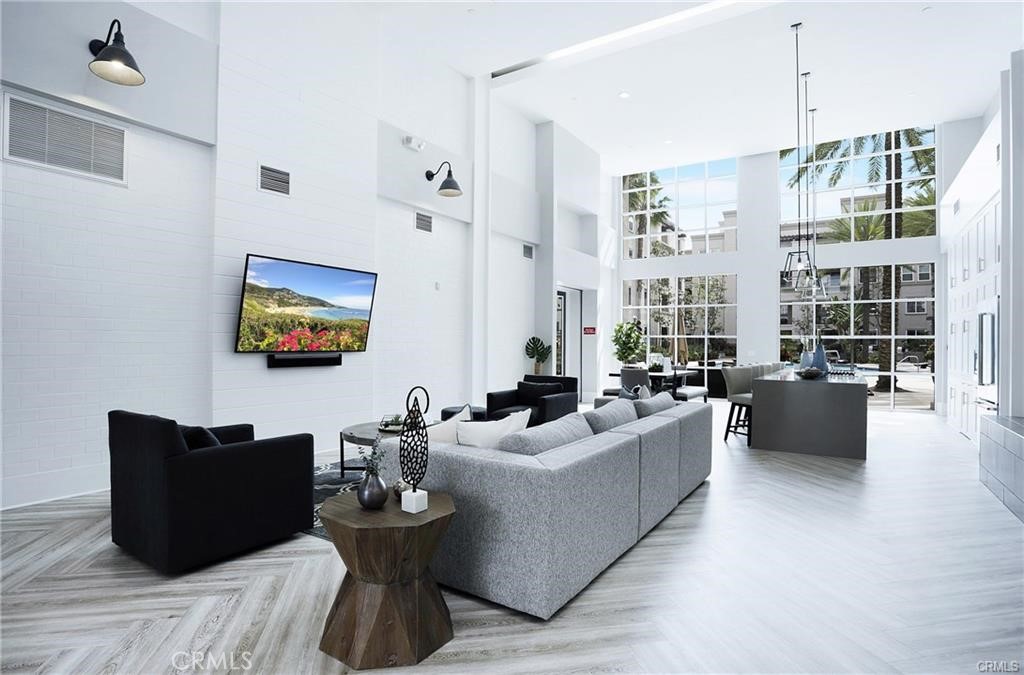 2420 Scholarship Irvine, CA 92612 - Photo 17 of 17 a living room with furniture wooden floor and a chandelier