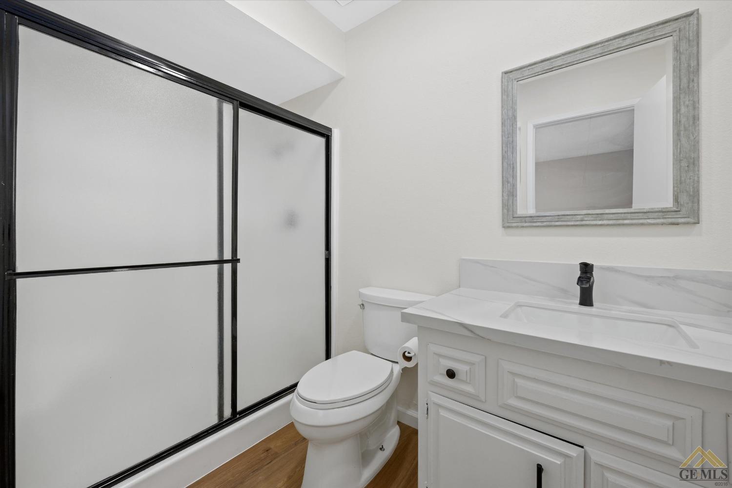 Undisclosed Address Taft, CA 93268 - Photo 3 of 3 a bathroom with a granite countertop sink toilet and a mirror