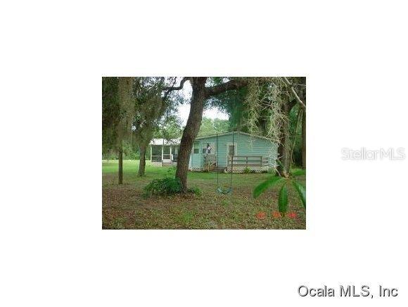 10680 Northeast 227th Place Road Fort McCoy, FL 32134 - Photo 1 of 1 a picture of a bench in a garden
