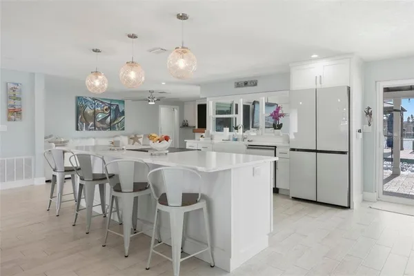 a kitchen with stainless steel appliances a dining table and chairs