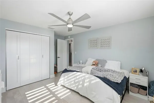 a bedroom with a bed and a chandelier