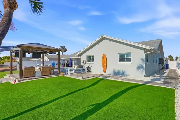 a view of a house with backyard porch and sitting area