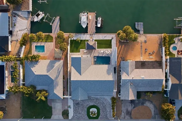 an aerial view of waterside residential houses with outdoor space and parking