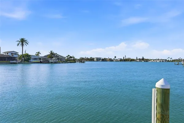 a view of a lake with houses in the back