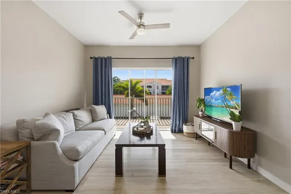 a living room with fireplace furniture and a flat screen tv