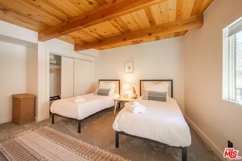 a bedroom with double bed and a window