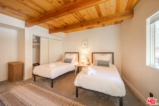 a bedroom with double bed and a window