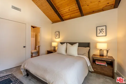 a bedroom with a bed and a night stand