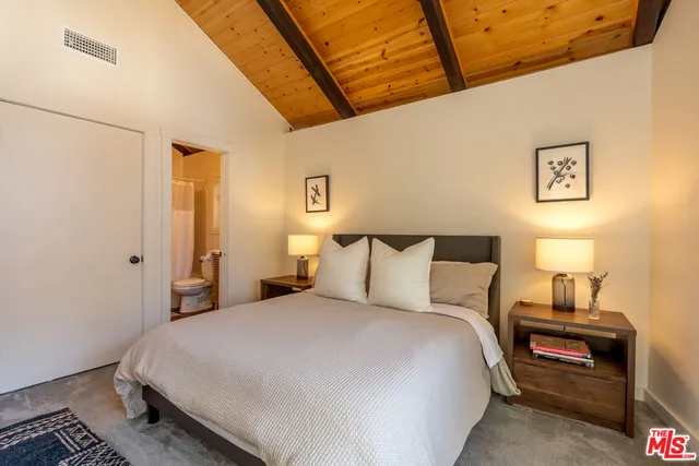 a bedroom with a bed and a night stand