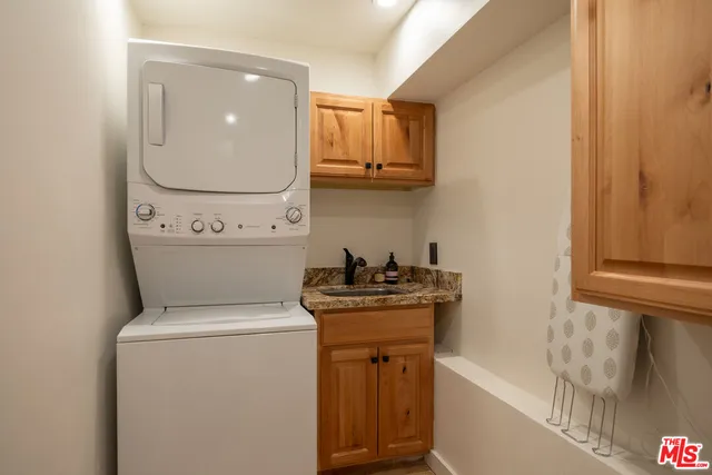 a utility room with sink dryer and washer