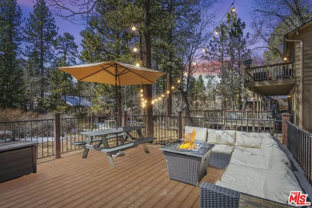 a view of a rooftop deck with couch and chairs
