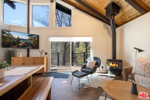 a living room with furniture and a floor to ceiling window