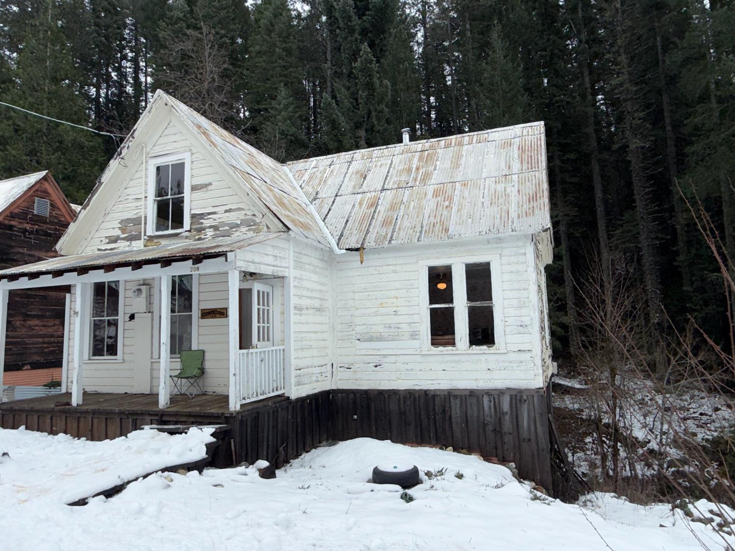 208 Main Street Alleghany, CA 95910 - Photo 16 of 24 a view of a white house with a large tree