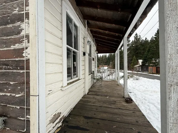 a view of a house with a yard covered in snow