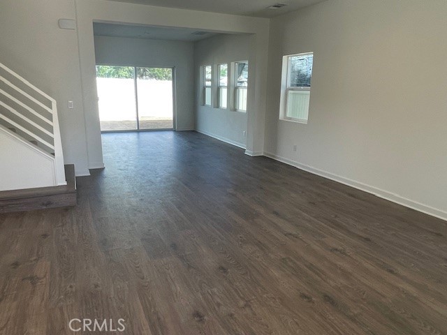 31960 Chagall Way Yucaipa, CA 92399 - Photo 4 of 12 a view of an empty room with wooden floor and a window