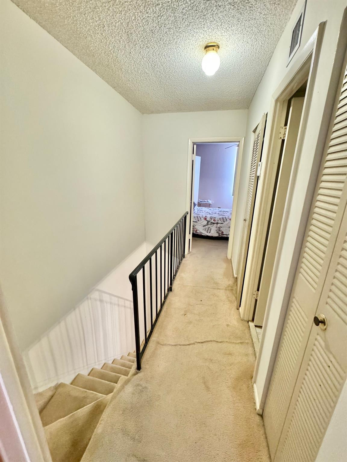 4357 West 11th Lane, Unit 55 Hialeah, FL 33012 - Photo 5 of 17 a view of a hallway with staircase