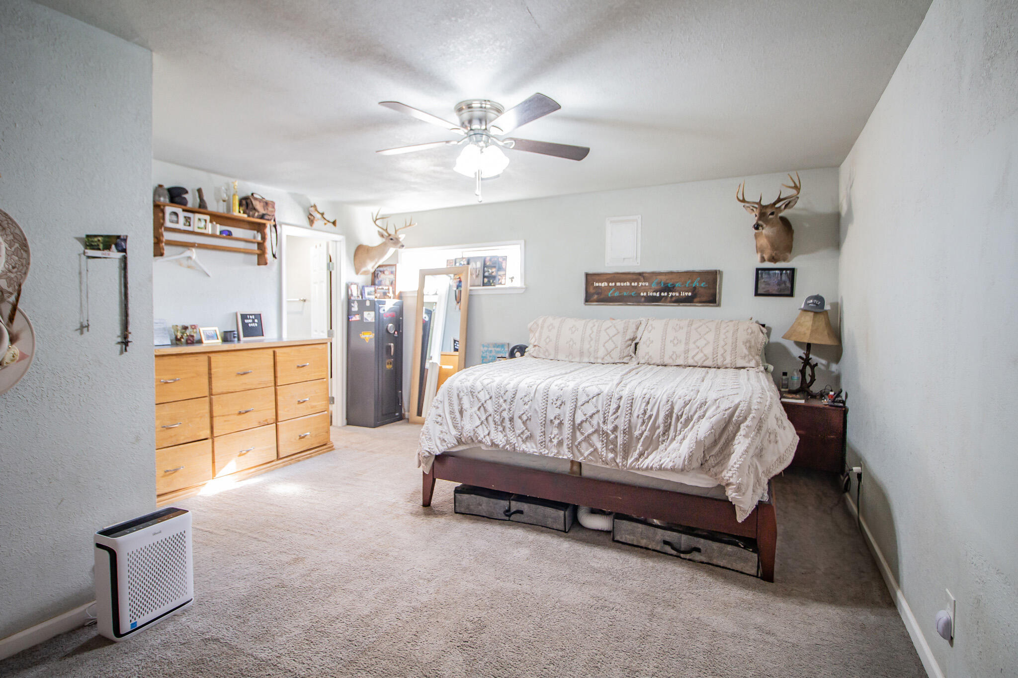 6403 23rd Street Lubbock, TX 79407 - Photo 14 of 29 a spacious bedroom with a bed and a cabinets