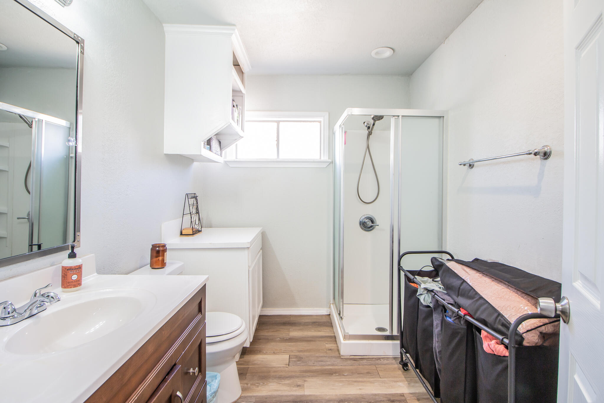 6403 23rd Street Lubbock, TX 79407 - Photo 15 of 29 a bathroom with a sink a toilet and shower