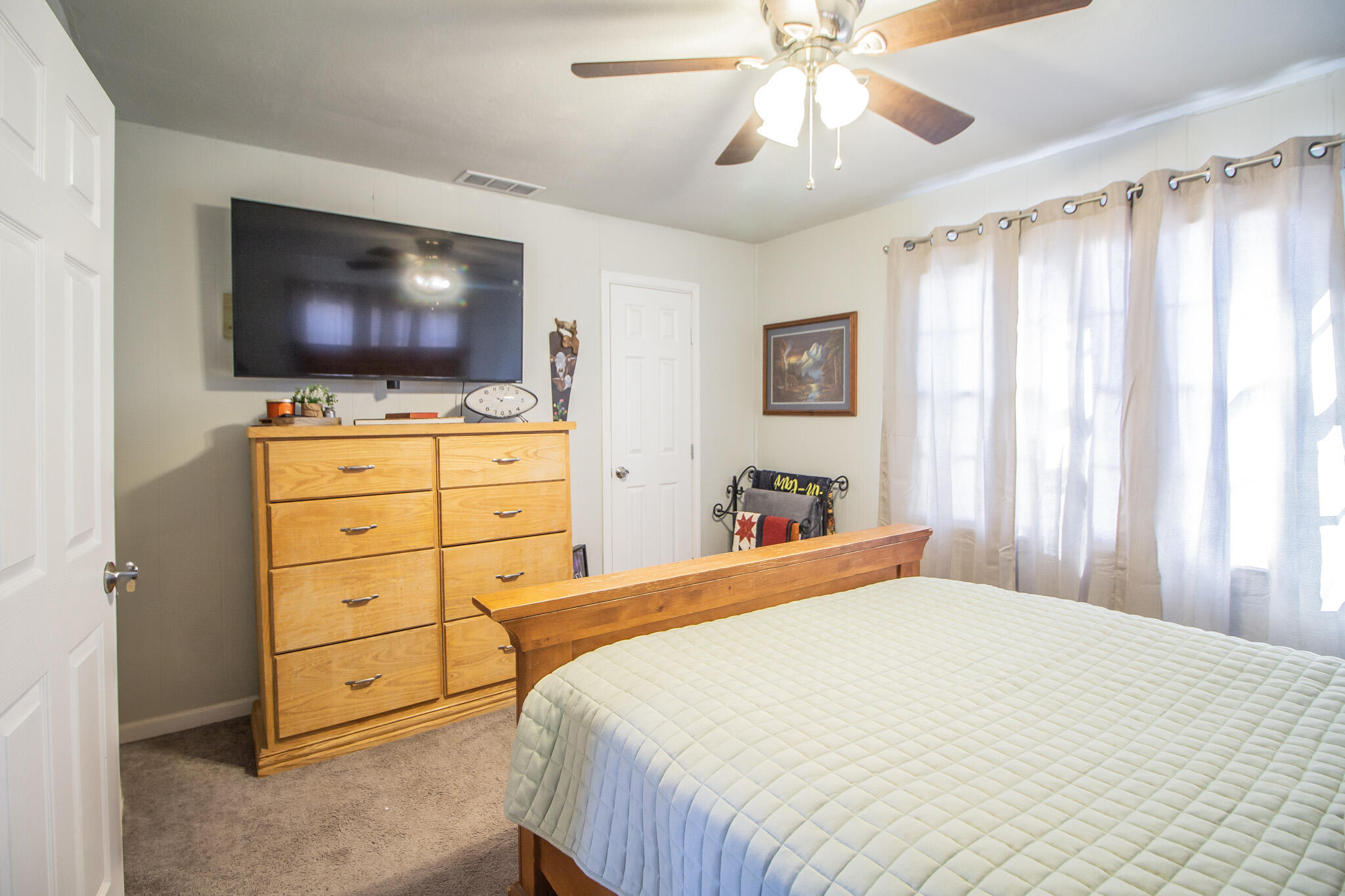 6403 23rd Street Lubbock, TX 79407 - Photo 17 of 29 a bedroom with a bed and a flat screen tv