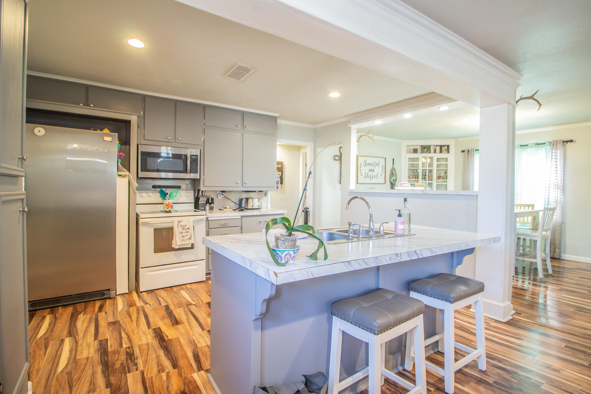 6403 23rd Street Lubbock, TX 79407 - Photo 8 of 29 a kitchen with granite countertop a sink appliances cabinets and counter space
