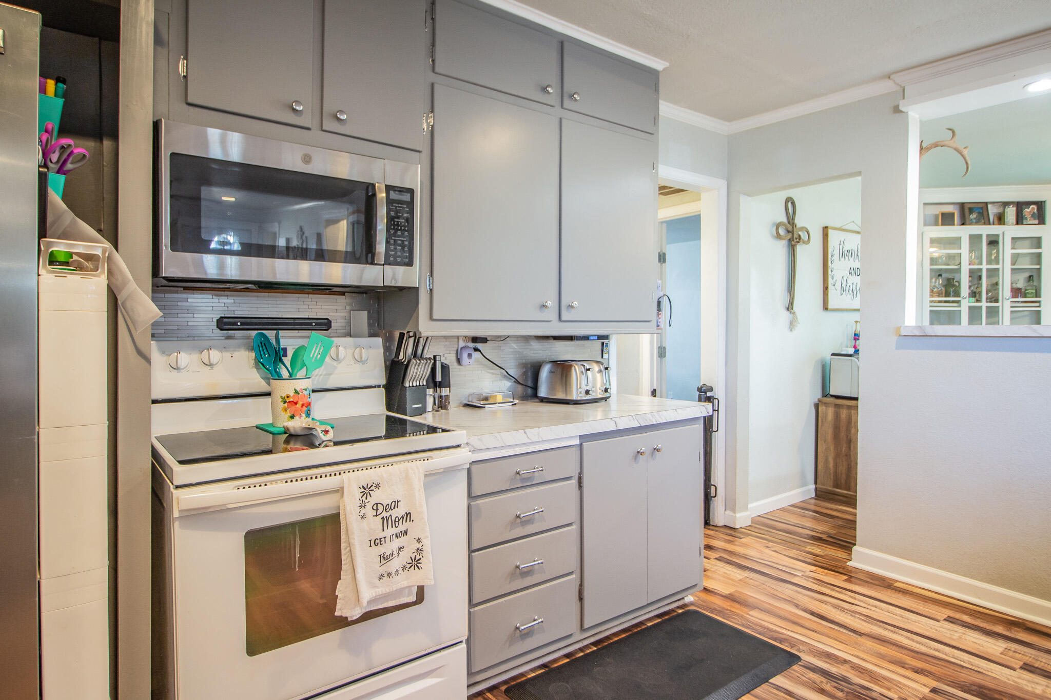 6403 23rd Street Lubbock, TX 79407 - Photo 10 of 29 a kitchen with stainless steel appliances white cabinets and a stove top oven