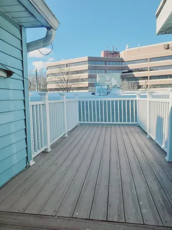 a view of a balcony with wooden floor