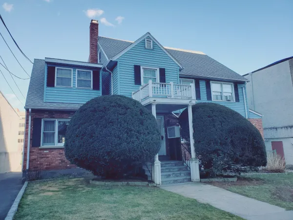 a front view of a house with garden