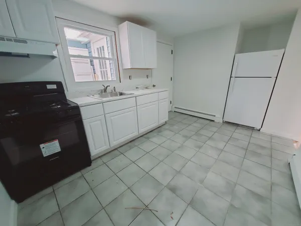a utility room with cabinets washer and dryer