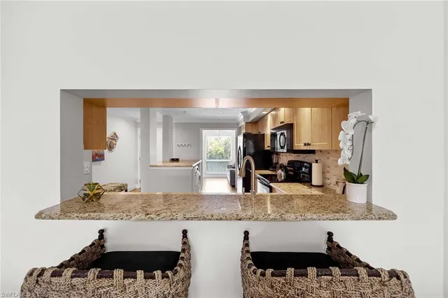 a living room with granite countertop kitchen island with furniture and rug
