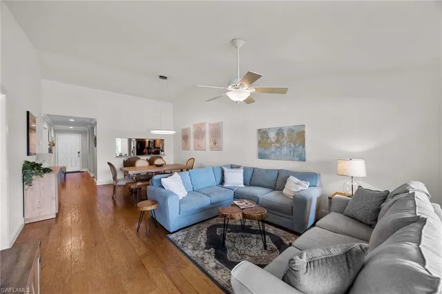 a living room with furniture kitchen view and a table