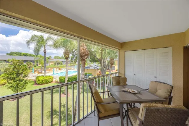 a view of a city from a dining room with furniture and window