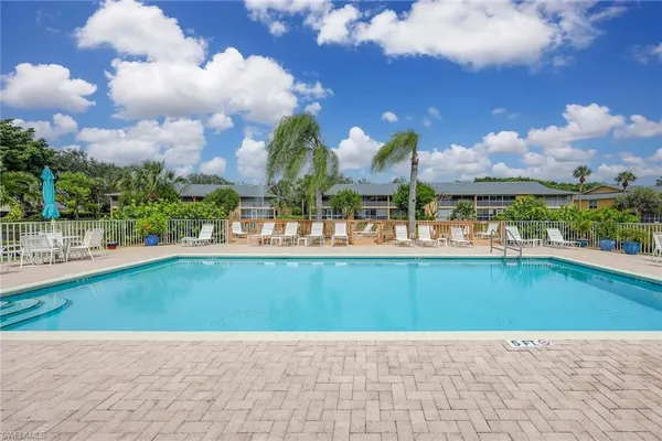 a view of a swimming pool and outdoor seating