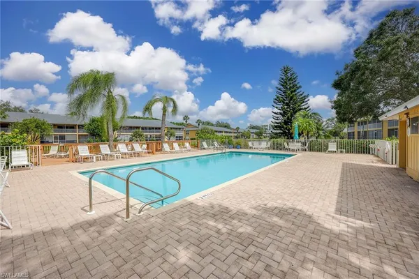 a view of a house with swimming pool and a yard