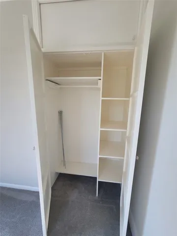 a view of room with a ceiling fan and window