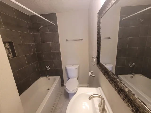 an empty room with wooden floor and closet