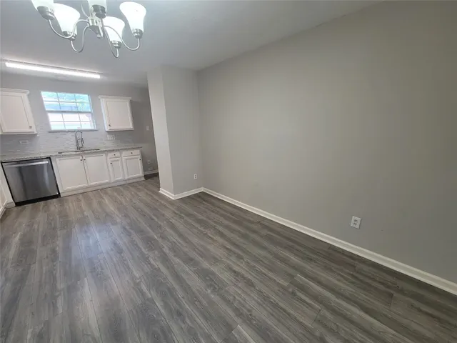 a kitchen with stainless steel appliances granite countertop a refrigerator a stove and a sink