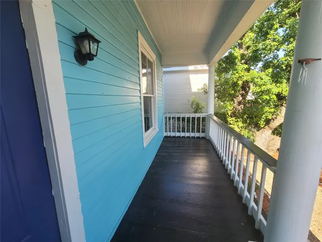 a view of a balcony with wooden floor