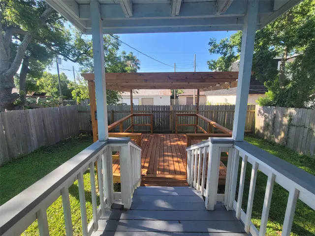 a front view of a house with wooden floor and outdoor seating