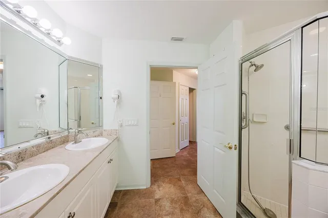 an empty room with windows and fan view