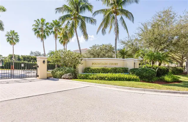 a view of a house with a yard and palm trees