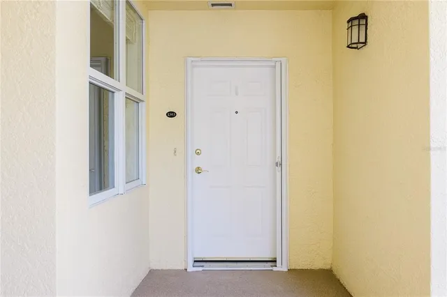a dining room with furniture a chandelier and wooden floor